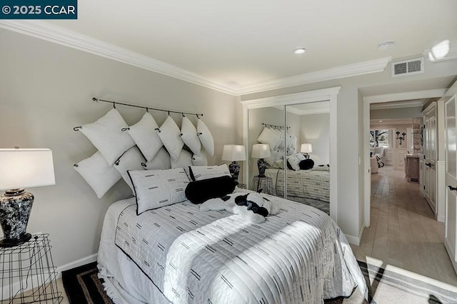 bedroom with wood-type flooring and ornamental molding