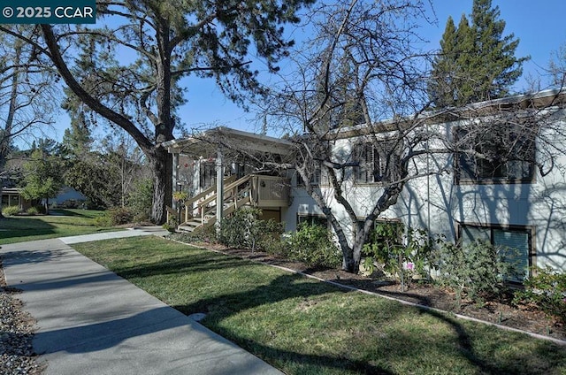 view of side of home with a yard