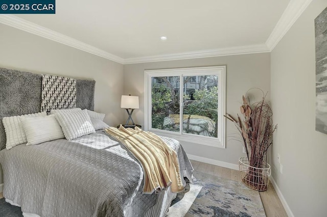 bedroom with wood-type flooring and ornamental molding