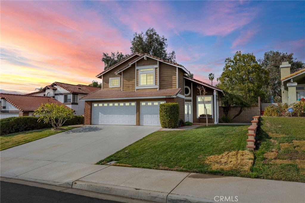 front of property featuring a garage and a lawn