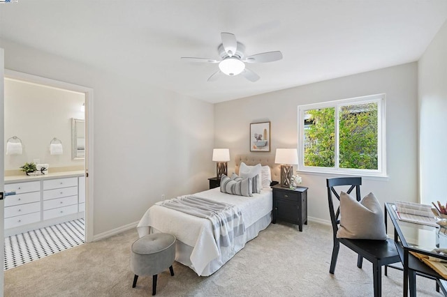 carpeted bedroom with ceiling fan and ensuite bathroom