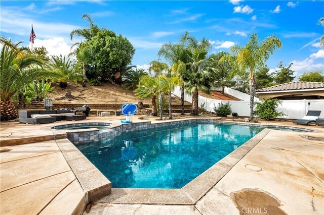 view of swimming pool with an in ground hot tub and a patio area