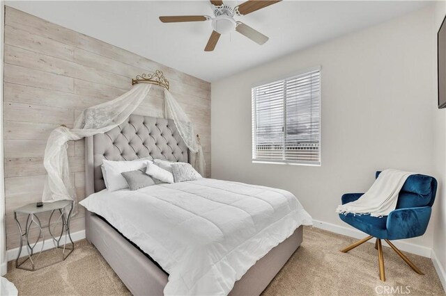 carpeted bedroom with wooden walls and ceiling fan