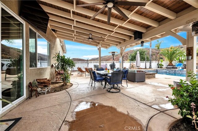 view of patio / terrace featuring a mountain view and a fenced in pool