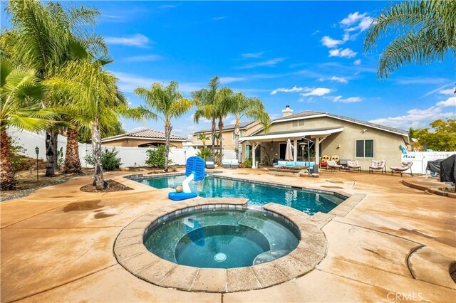 view of swimming pool with a patio and an in ground hot tub