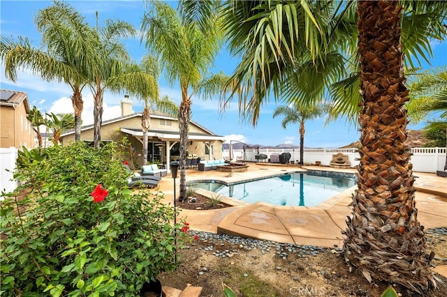 view of swimming pool with a patio, a fenced backyard, a fenced in pool, and an outdoor hangout area