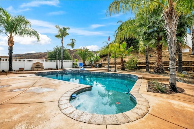 view of pool featuring a mountain view and a patio area