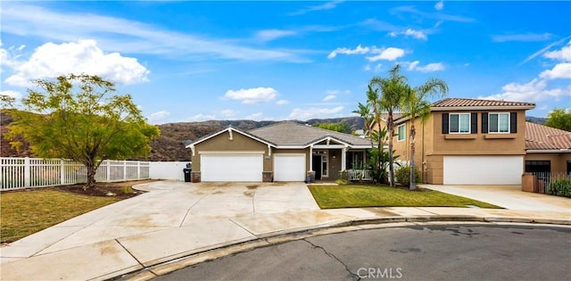 view of front of house with a front lawn, fence, and stucco siding