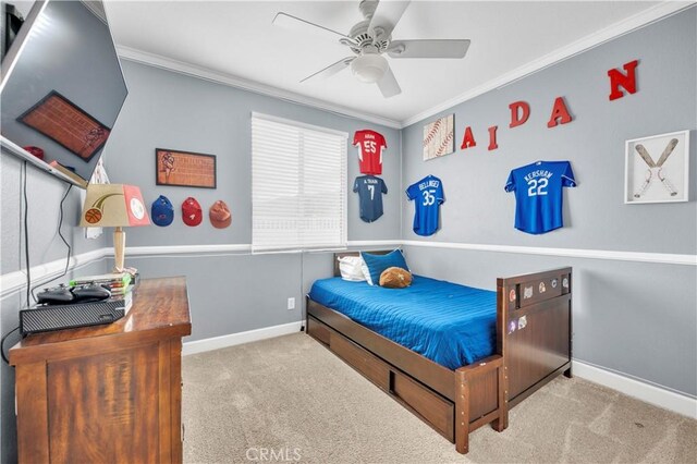 bedroom featuring ornamental molding, light colored carpet, and ceiling fan