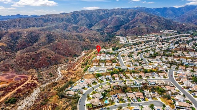 birds eye view of property with a mountain view