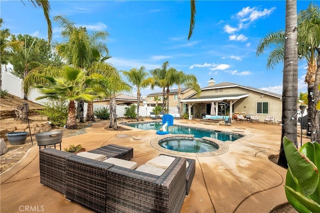 view of swimming pool featuring an in ground hot tub, an outdoor hangout area, and a patio area