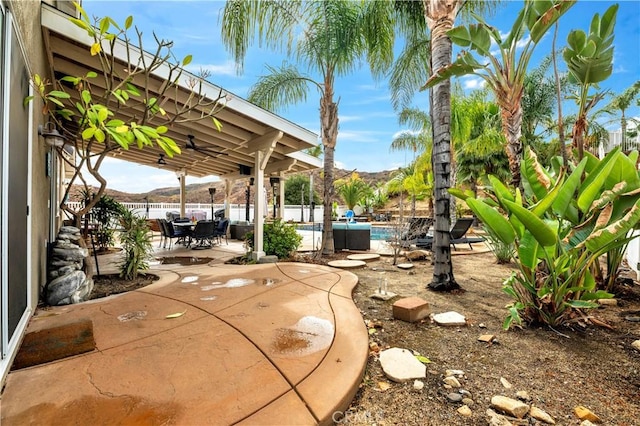 view of patio with a mountain view and a fenced in pool