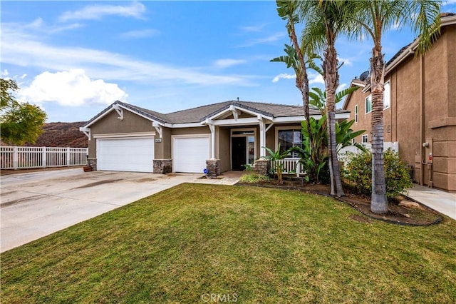 view of front of home with stucco siding, a front lawn, fence, concrete driveway, and a garage