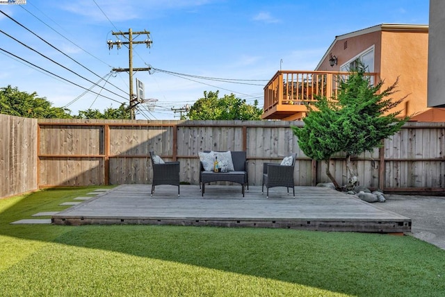 wooden deck featuring a lawn