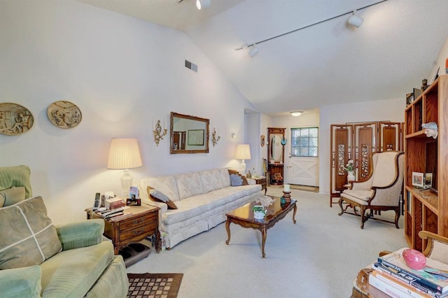 living room with light carpet, high vaulted ceiling, and rail lighting