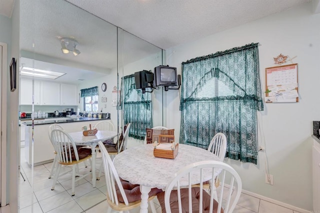 dining room featuring light tile patterned floors and a textured ceiling