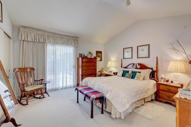 bedroom with vaulted ceiling, carpet flooring, and access to outside