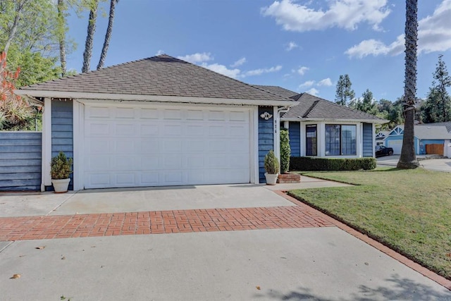 ranch-style house with a garage and a front lawn