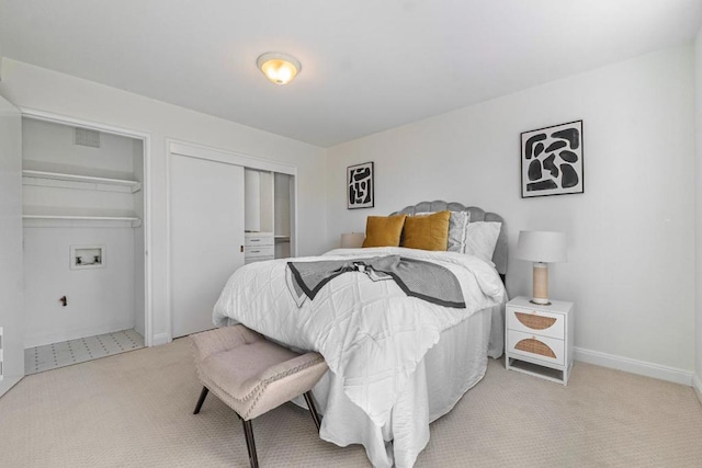 carpeted bedroom featuring two closets