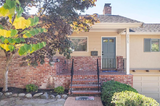 view of exterior entry with a garage