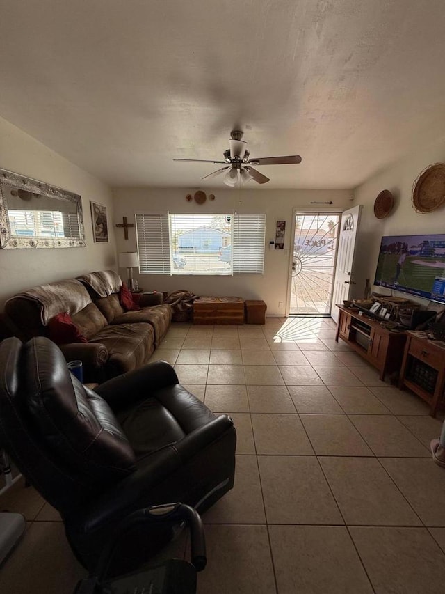 living room with light tile patterned floors and ceiling fan