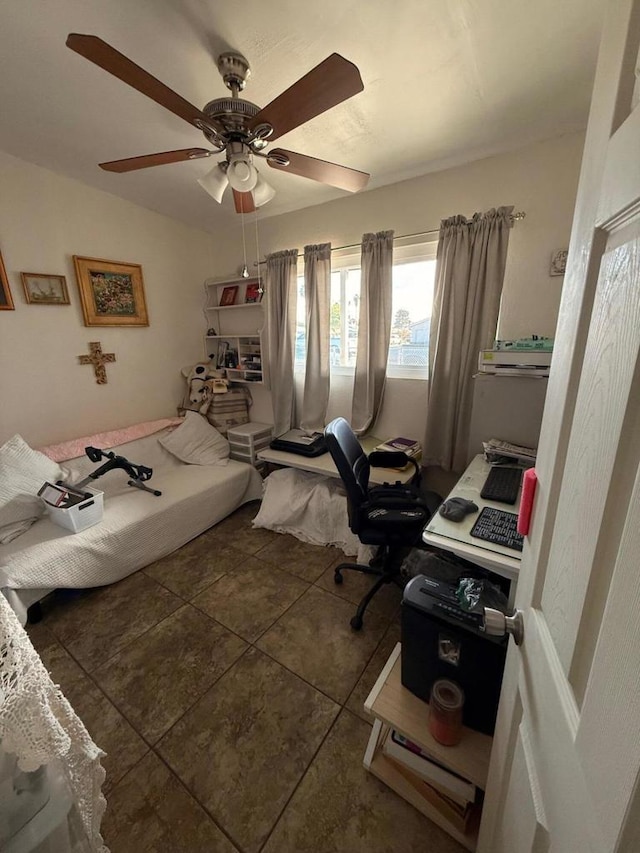 tiled bedroom featuring ceiling fan