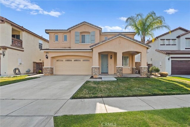 view of front of property featuring a garage and a front yard