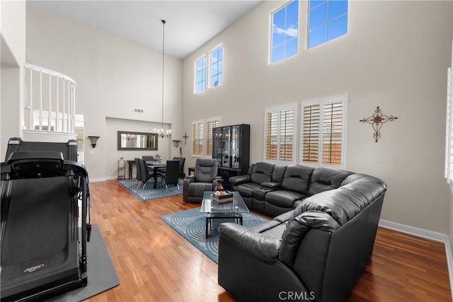 living room featuring hardwood / wood-style flooring and a notable chandelier