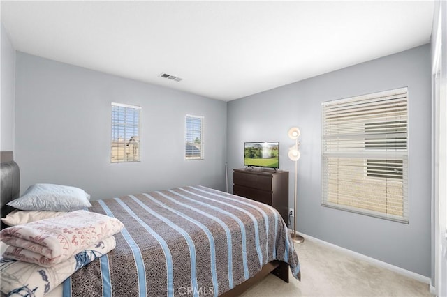 bedroom featuring light colored carpet