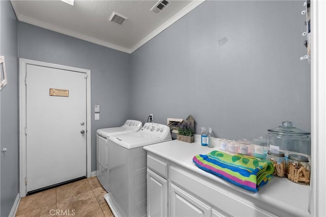 clothes washing area featuring crown molding, independent washer and dryer, light tile patterned flooring, and cabinets