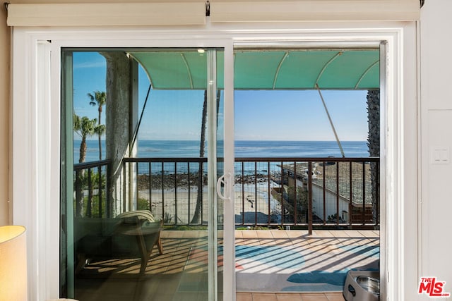 doorway to outside with a water view