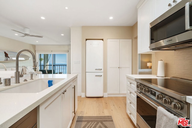 kitchen with white cabinetry, appliances with stainless steel finishes, and sink