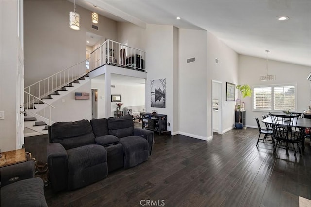 living room featuring wood-type flooring and high vaulted ceiling