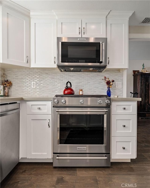 kitchen featuring white cabinetry, appliances with stainless steel finishes, and dark hardwood / wood-style floors