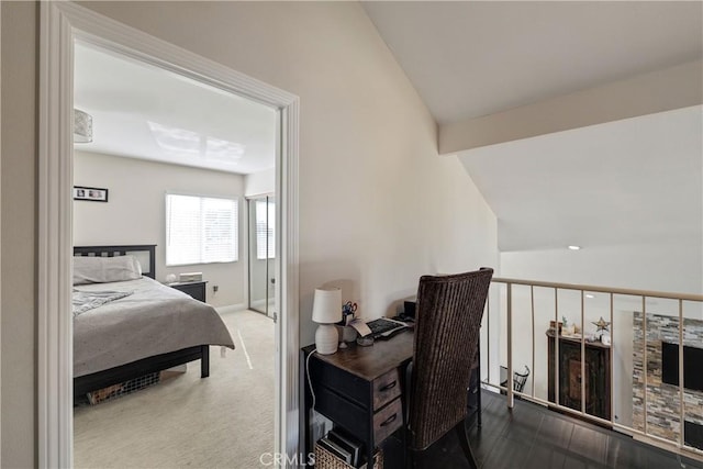 bedroom featuring lofted ceiling and carpet flooring