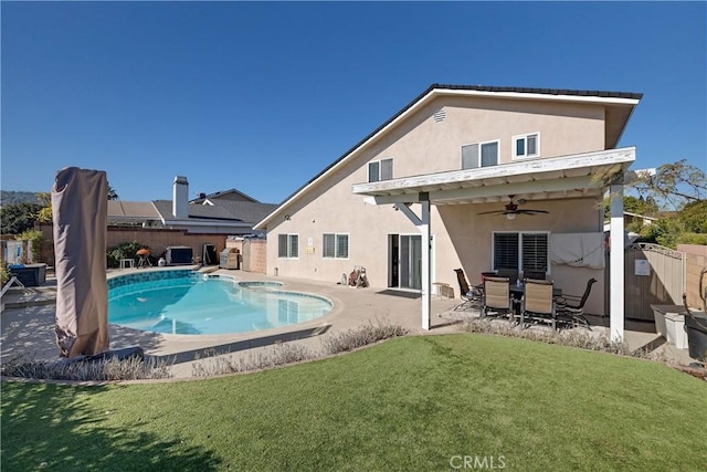 view of pool featuring ceiling fan, a patio area, and a lawn