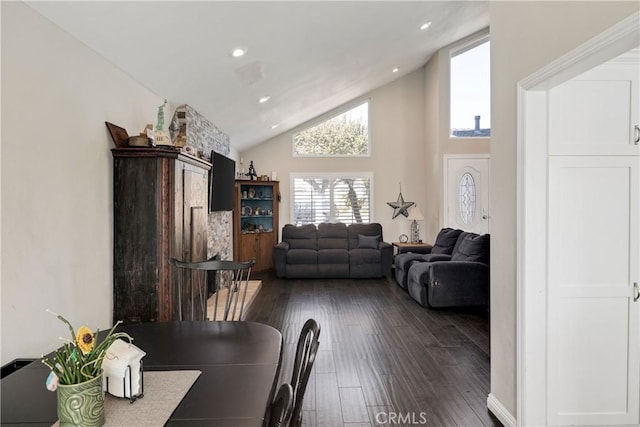 dining space featuring dark wood-type flooring and high vaulted ceiling