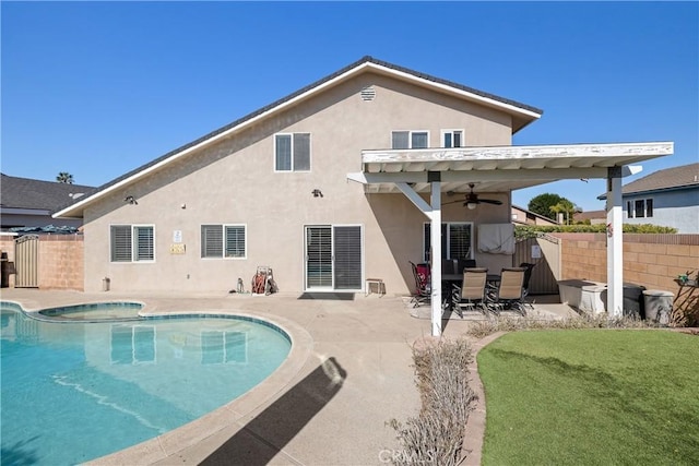 back of house featuring a fenced in pool, a yard, a patio area, and ceiling fan