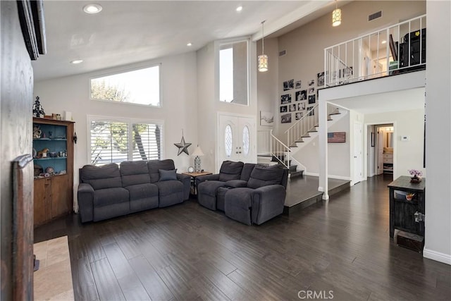 living room with dark hardwood / wood-style floors and high vaulted ceiling