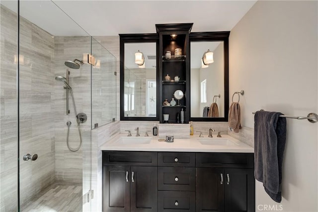 bathroom featuring tasteful backsplash, tiled shower, and vanity