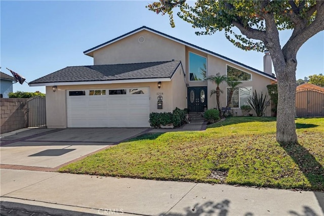 view of front of house featuring a garage and a front yard