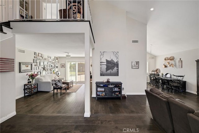 interior space with dark hardwood / wood-style floors and high vaulted ceiling