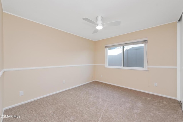 empty room featuring carpet flooring and ceiling fan