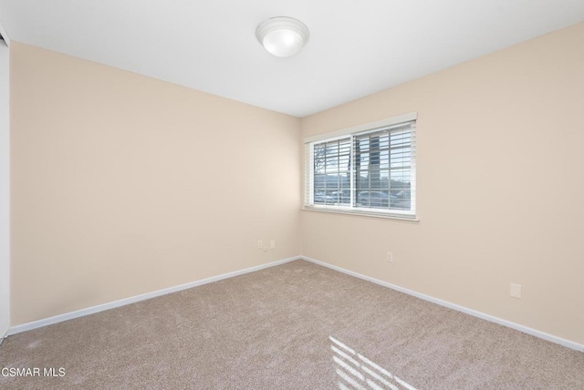 spare room with light carpet