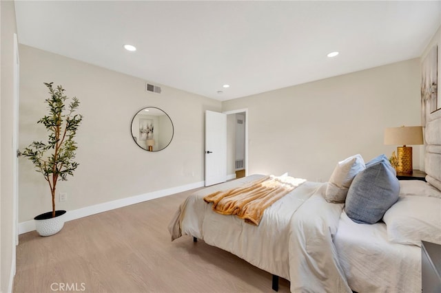 bedroom featuring recessed lighting, wood finished floors, visible vents, and baseboards