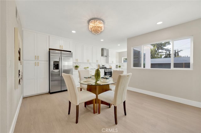 dining area featuring recessed lighting, baseboards, and light wood finished floors