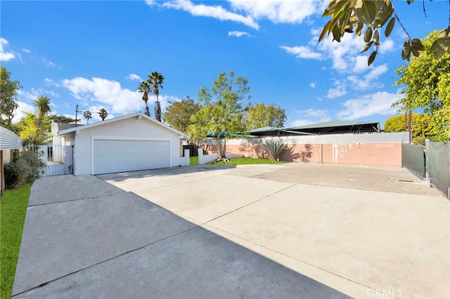 view of side of property with a garage and fence