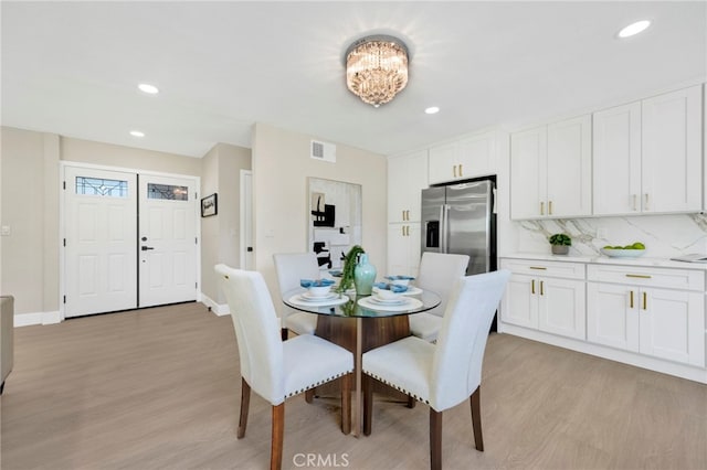 dining room featuring recessed lighting, baseboards, visible vents, and light wood finished floors