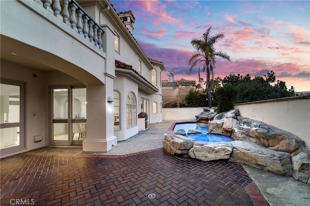 view of patio terrace at dusk