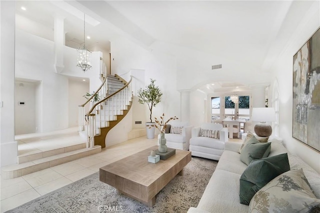 tiled living room featuring a chandelier